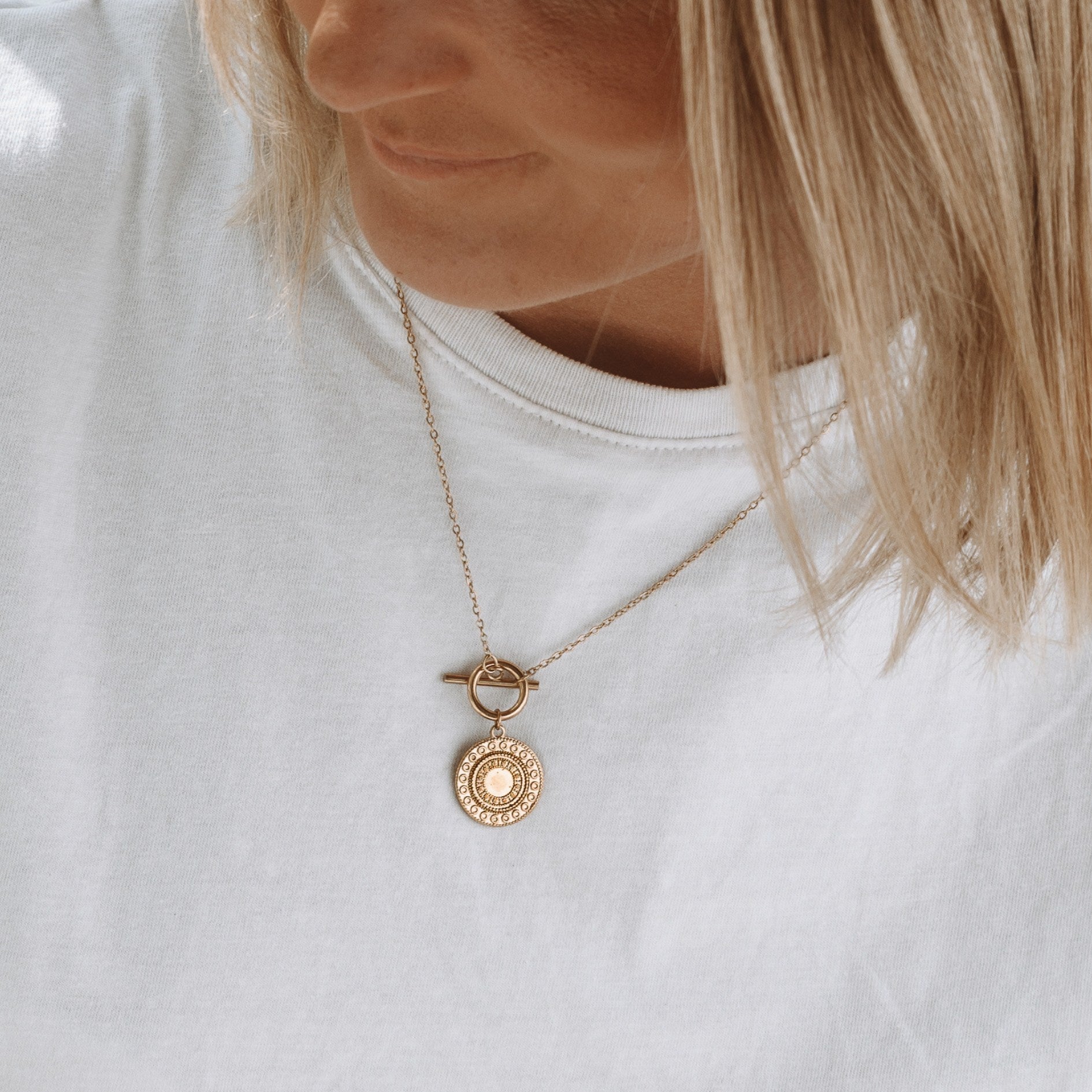 helios-necklace-on-model-white-shirt