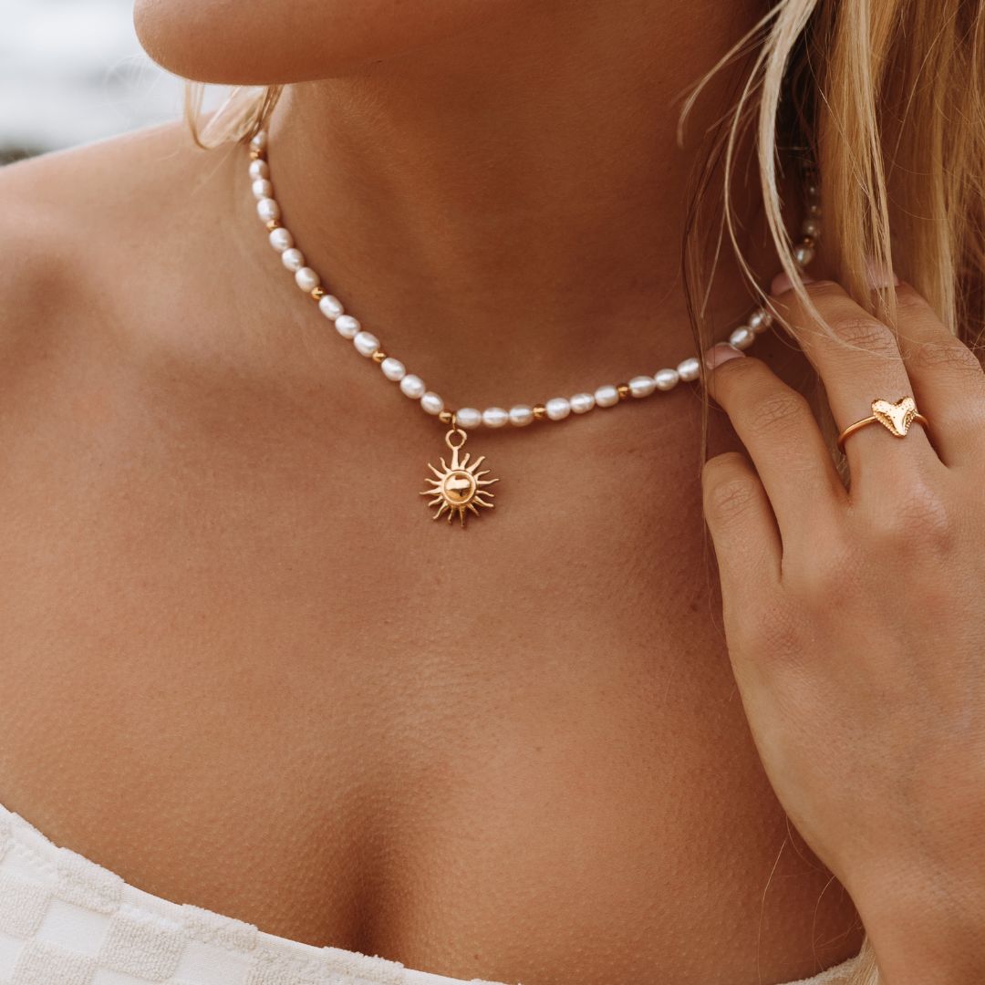 sun-pendant-gold-necklace-on-model