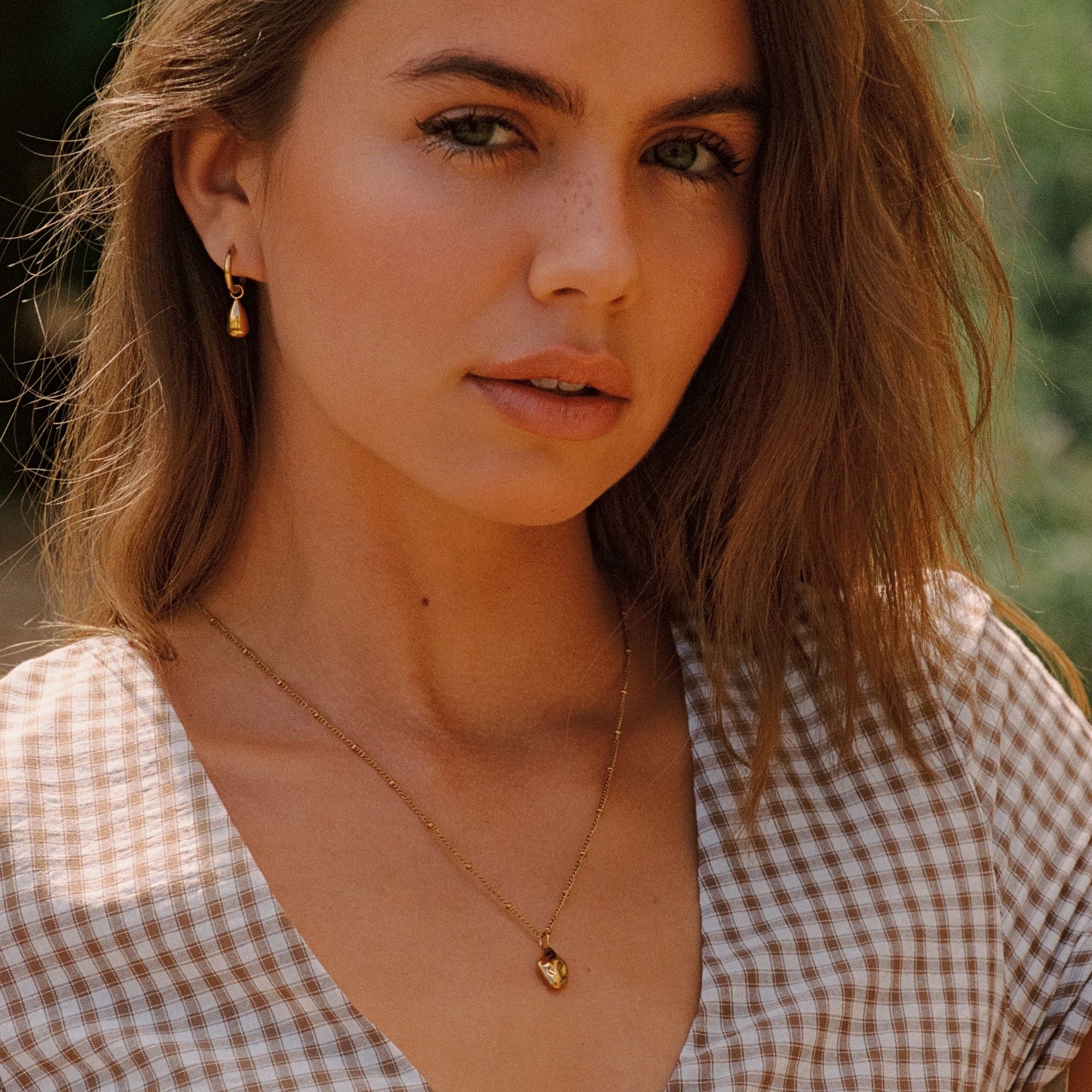 Woman Wearing Goldie Necklace