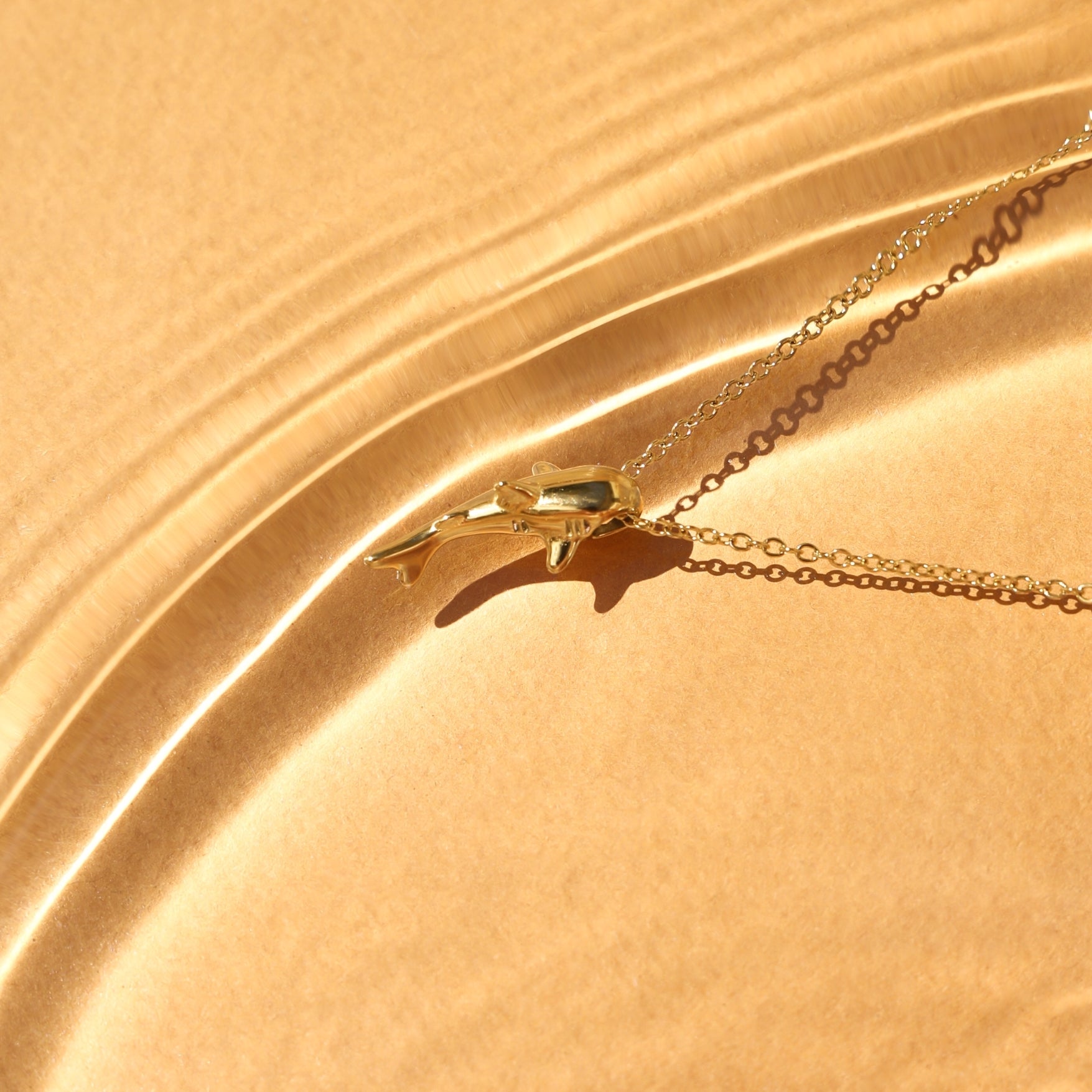 shark-necklace-pendant-water-reflection