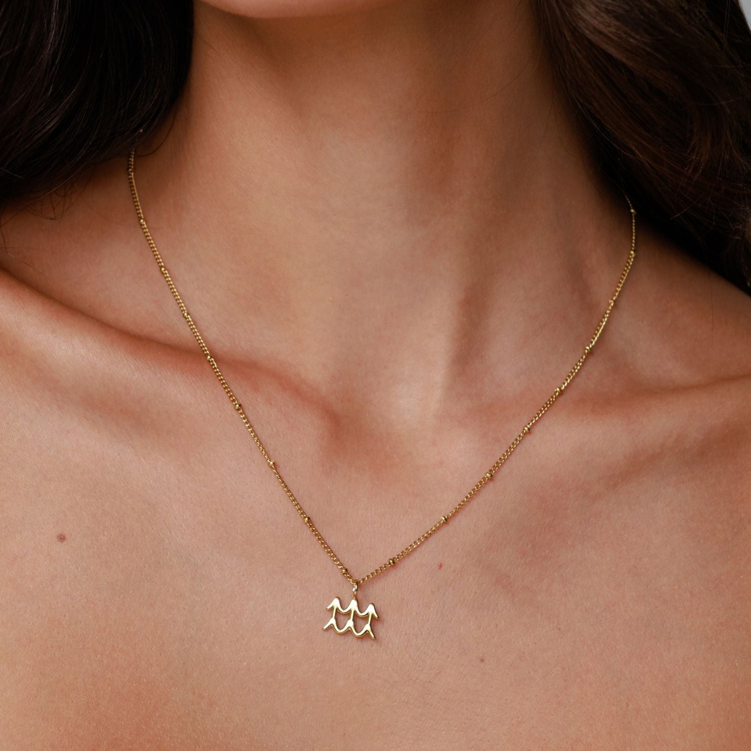Woman Wearing Zodiac Necklace
